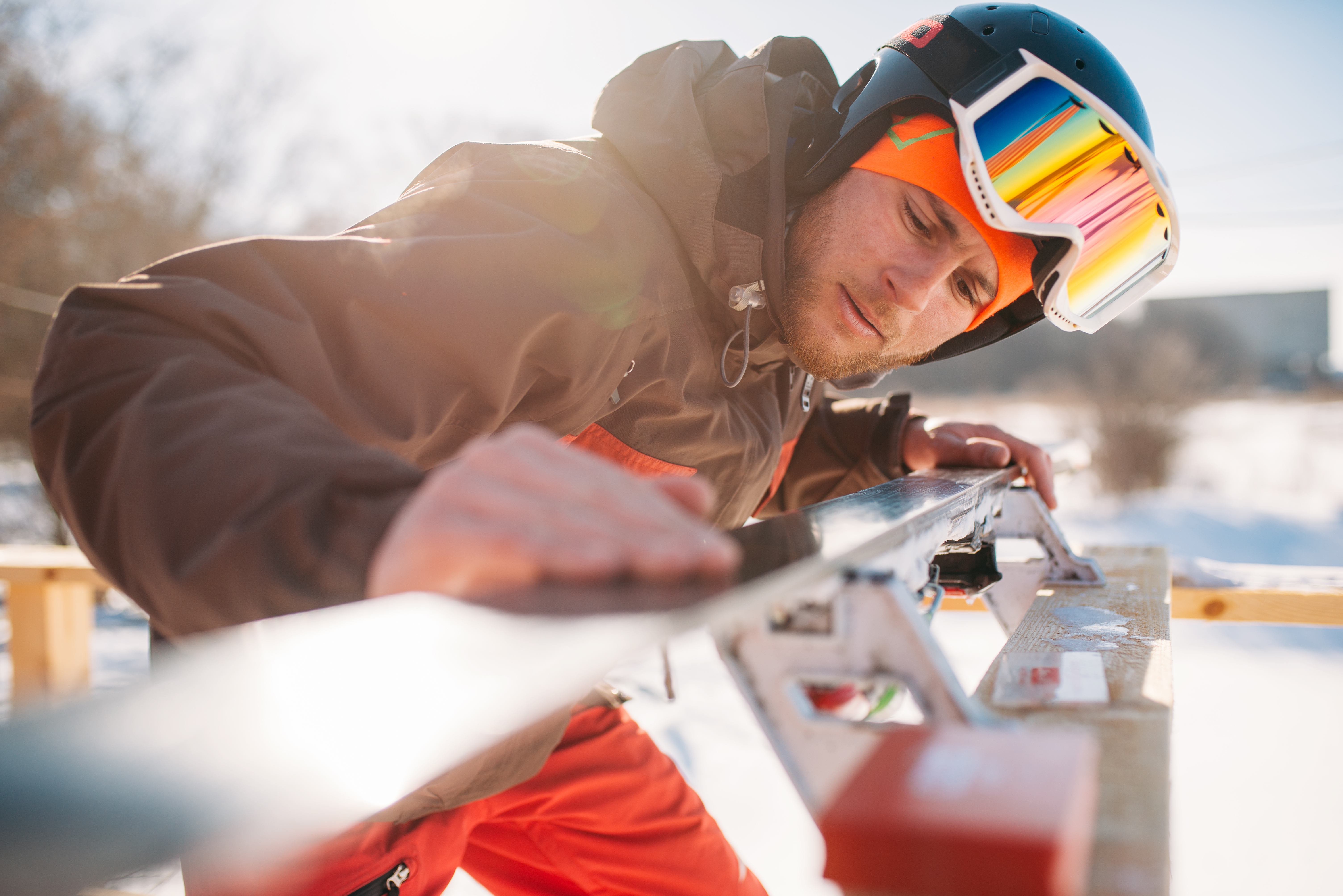 male skier checks skis before skiing winter sport